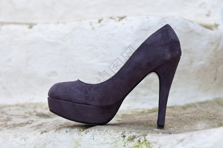 白色原石上的时尚紫色鞋背景图片