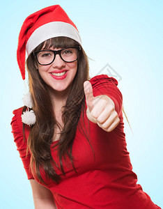 圣诞节妇女用拇指在蓝背图片