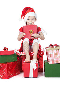 美丽的小女孩穿在圣诞老人的帮手帽子图片
