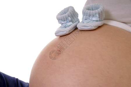 拿着小婴儿鞋的孕妇图片