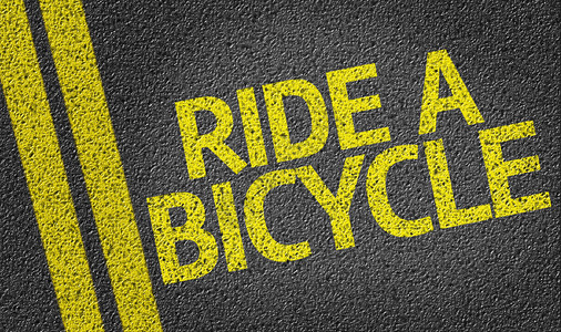 骑自行车写在道路背景上背景图片
