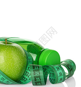 健身减肥概念与绿色苹果瓶饮用水和卷尺隔图片