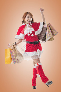 亚洲圣诞女孩拿着购物袋图片