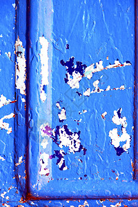 蓝色木门上的钉子剥落了油漆生锈了图片