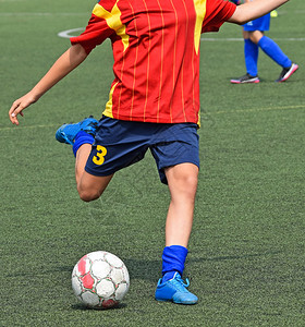 年轻足球运动员踢球图片