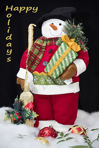 雪人穿着圣诞老人的衣服带礼物图片