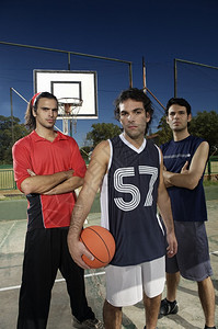 三名篮球运动员在球场上带球图片
