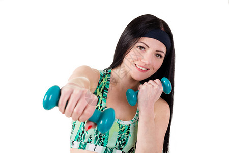 长头发的美丽的黑发美女被训练用蓝哑铃打拳图片