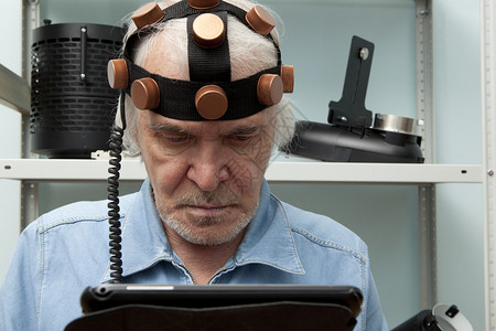 戴头盔大脑研究的老人疯狂发明家背景图片