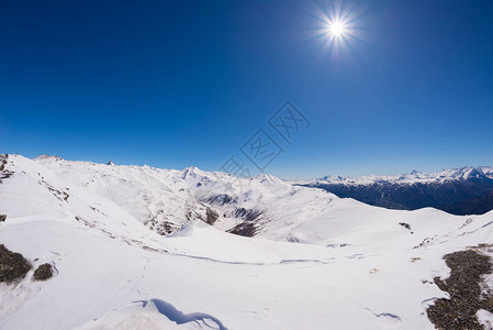 太阳星在意大利高山弧的白雪皑的山脉和高山峰上发光图片