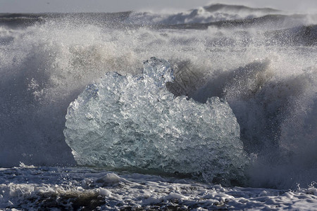 冰河的冰块破裂被冰岛北大西洋海的强烈波浪冲到岸边图片