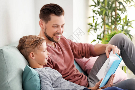 父亲和儿子在家一起看书图片