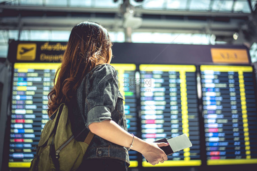 游客看航班时刻表检查起飞时间人和生活方式的概念旅行和幸福生活的单身女主题后景肖像图片