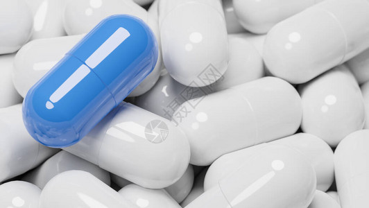 关闭许多白色药丸胶囊中的蓝色药丸胶囊医学和特种药物概念图片