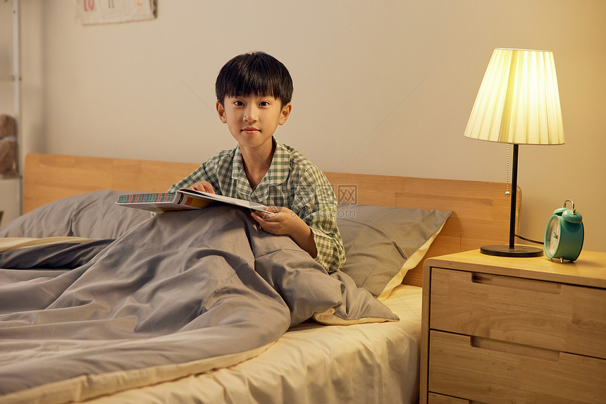 穿睡衣阅读的小男孩图片