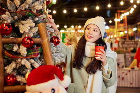 圣诞节浪漫冬日女性手捧咖啡逛圣诞集市背景
