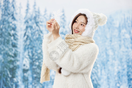 手拿雪花片的冬季女孩背景图片