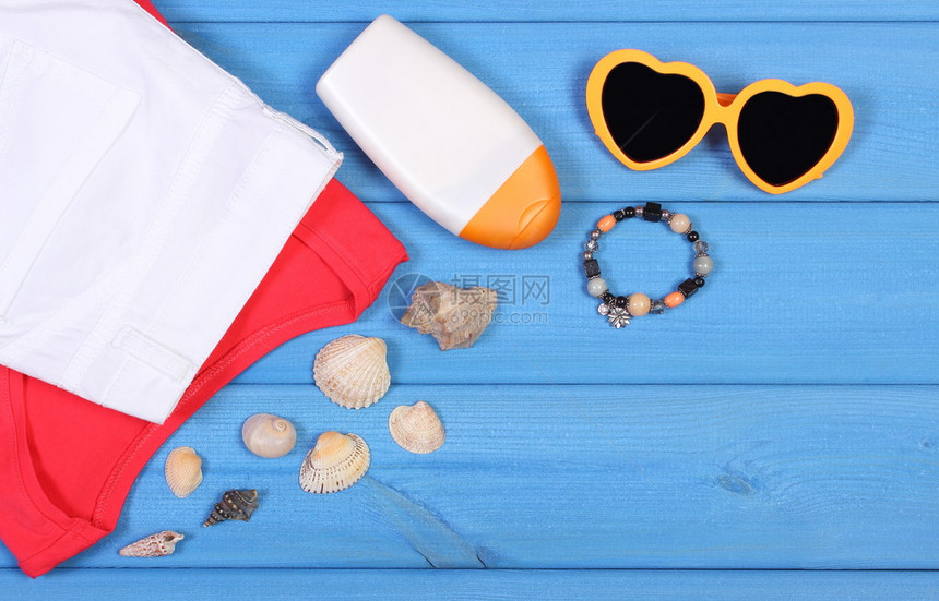 妇女服装和在蓝板太阳墨镜阳光润晒衬衫裤子文本复制空间上的假期图片