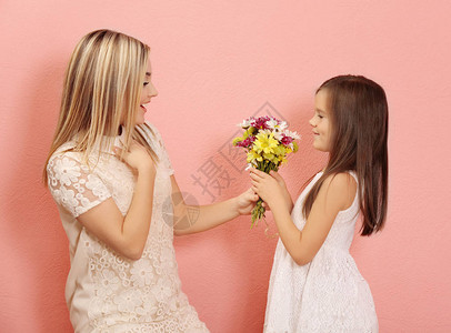 小女孩用彩色背景给母亲送花束子给妈母高清图片