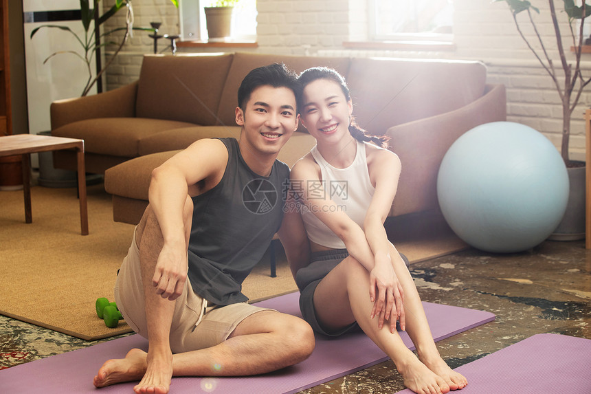 青年夫妇在家健身中场休息图片