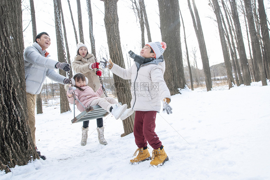 快乐的一家人在雪地里玩耍图片