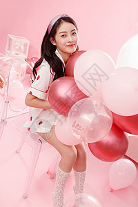 卧室粉色漂亮的年轻女孩和气球背景
