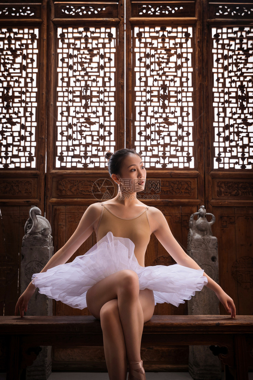芭蕾舞演员坐在中式古典门前图片