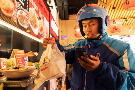 外卖员在餐厅取餐制服高清图片素材