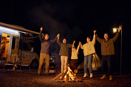 一家人露营篝火派对欢呼图片