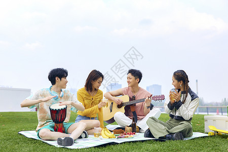 青年人户外野餐弹琴唱歌图片