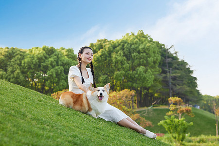 端午节玩耍少女草地上的宠物狗和少女背景