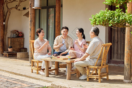 年轻夫妻节假日回家陪父母喝茶聊天节日高清图片素材