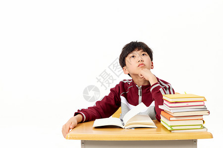 小男孩写作业时思考教育高清图片素材