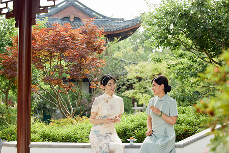 院子里吃点心喝茶聊天的母女背景图片