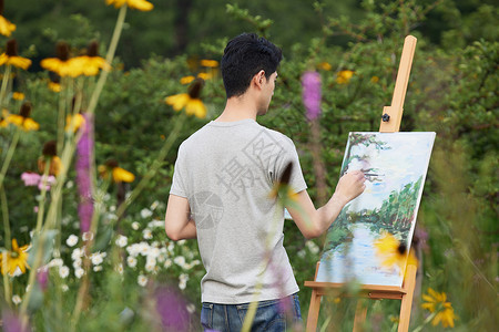 青年节男孩艺术家在公园里写生背景