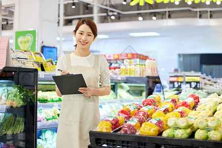 超市蔬菜区女店员形象背景图片