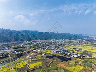 航拍油菜花航拍贵州万峰林油菜花风光背景