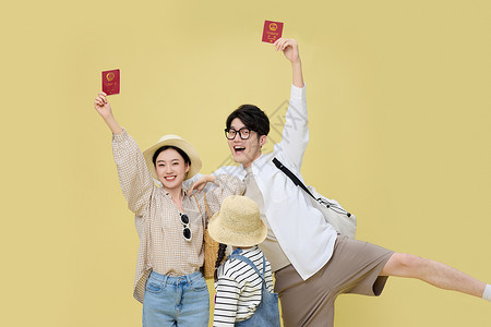 手里高举护照欢乐展示的年轻父母高清图片