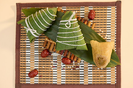 节日美食背景一片粽叶上的三个粽子鸟瞰图背景