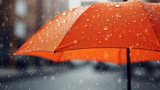 雨伞背景从橙色雨伞落下的雨滴背景
