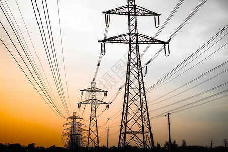 直流输电日落时分的输电塔高压电线景观设计图片