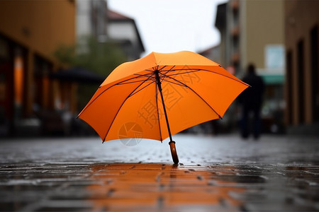 街道的路面上有一把雨伞背景