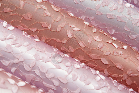 粉色丝绸上的小花高清图片