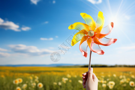 手捧太阳鲜花海中一个孩子手捧风车背景