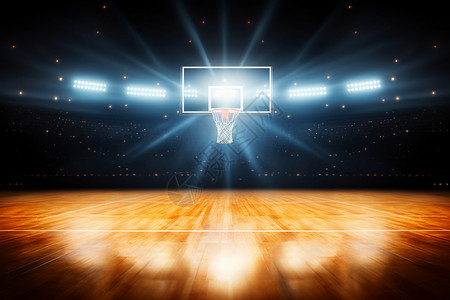 篮球和篮球框灯光下的篮球场背景