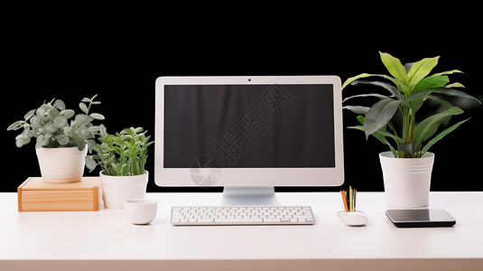 白色的桌上的电脑和植物图片