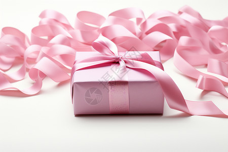 礼物盒上绑着粉红色丝带背景图片