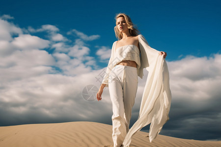一个穿着白色衣服的女士在沙漠里背景图片