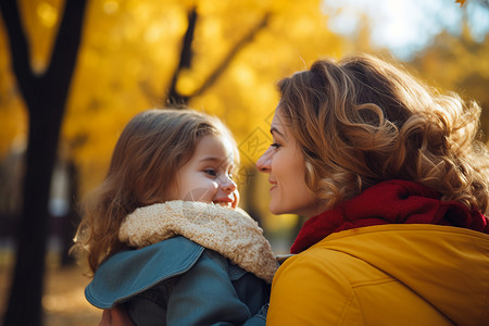 女儿亲吻着妈妈秋天公园里的母女背景