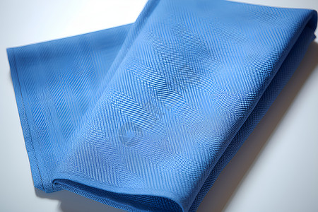 折叠好的蓝色桌布背景图片